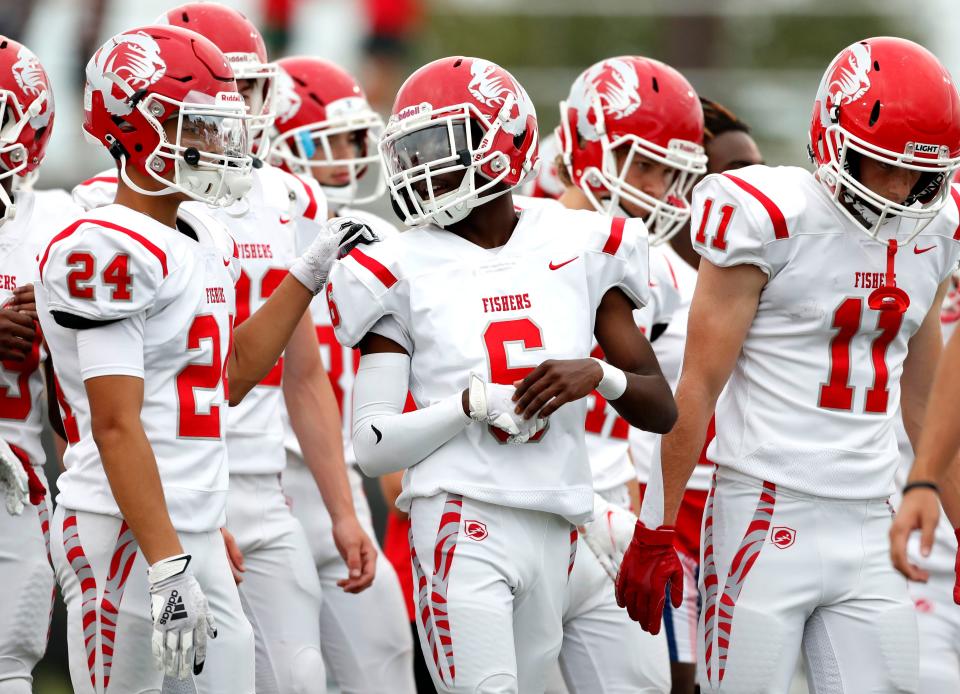 Fishers High School's Leo Morrow (24) and Leonard Teyon (6) talk during practice prior to the game Friday, Sept. 3, 2021, at Noblesville High School.