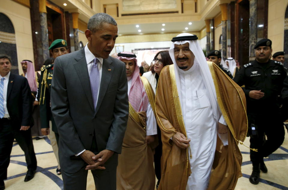 Obama walks with Saudi King Salman at Erga Palace upon arriving for a summit meeting in Riyadh.