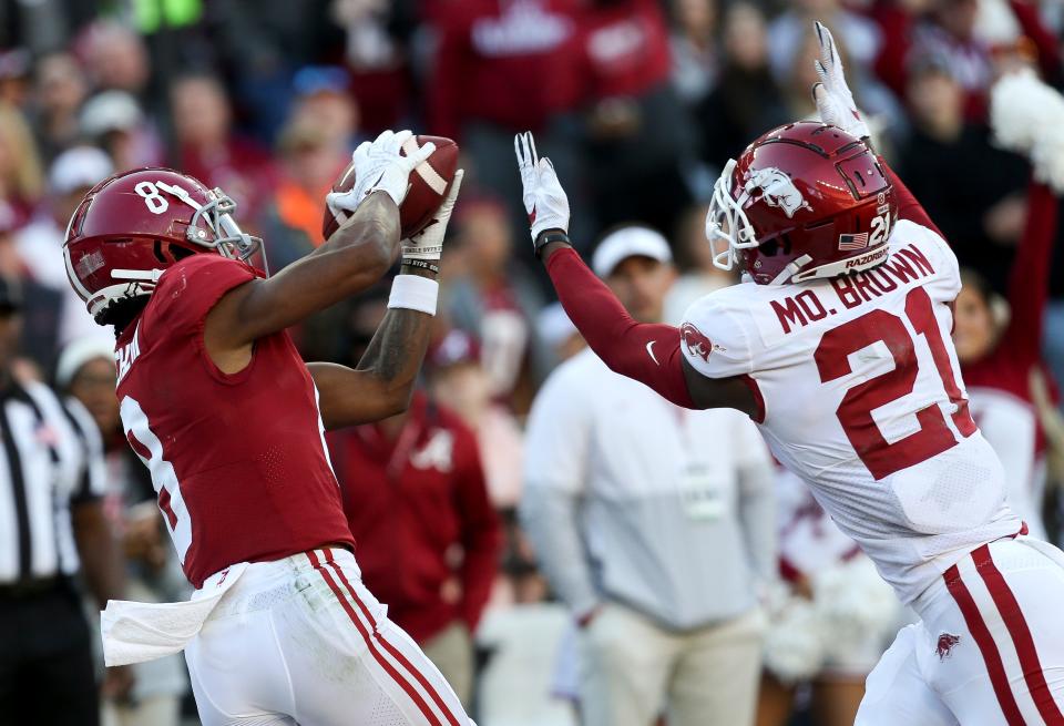 Nov 20, 2021; Tuscaloosa, Alabama, USA;  Alabama wide receiver John Metchie III (8) catches a touchdown pass behind Arkansas defensive back Montaric Brown (21) at Bryant-Denny Stadium. Mandatory Credit: Gary Cosby Jr.-USA TODAY Sports