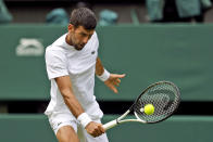 Serbia's Novak Djokovic practices on Center Court ahead of the 2022 Wimbledon Championship at the All England Lawn Tennis and Croquet Club, in London, Thursday, June 23, 2022. (Steven Paston/PA via AP)