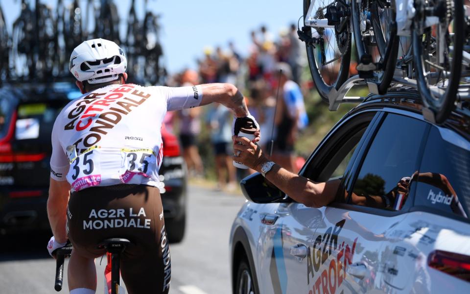 Stan Dewulf takes a bidon from an Ag2r-Citroën team car - GETTY IMAGES