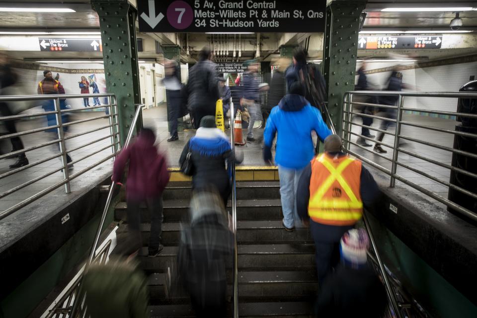 Commuters exit a train during the evening rush hour near the tunnel that connects the Times Square subway station to the Port Authority Bus Terminal, Dec. 11, 2017 in New York City.