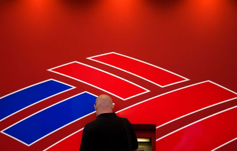 FILE PHOTO: A man uses a Bank of America ATM near the Bank of America corporate headquarters in Charlotte