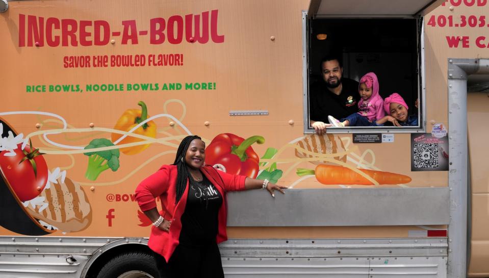 Sterling Clinton-Spellman stands in front of one of her Incred-A-Bowl food trucks with her husband (and chef), Russell Spellman, and their daughters, Harmony, 2, and Hasana, 7.