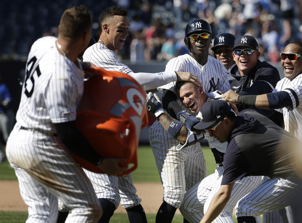 New York Yankees' Gleyber Torres, center right, celebrates his walk-off RBI single with teammates after the baseball game against the Toronto Blue Jays at Yankee Stadium, Wednesday, June 26, 2019, in New York. The Yankees defeated the Blue Jays 8-7. (AP Photo/Seth Wenig)