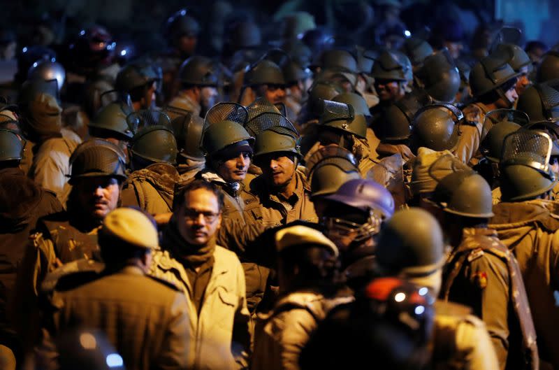 Police in riot gear stand guard inside the Jawaharlal Nehru University (JNU) after clashes between students in New Delhi