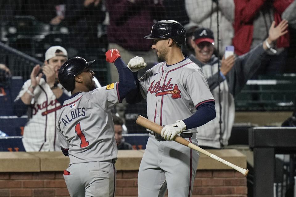 Atlanta Braves' Ozzie Albies, left, celebrates with Matt Olson after hitting a home run against the New York Mets during the third inning of a baseball game Friday, May 10, 2024, in New York. (AP Photo/Frank Franklin II)