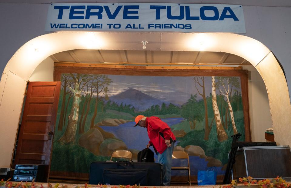 Glenn Adams, 87, of Republic, sets up his keyboard and speakers on the stage at the historic Herman Hall before the start of the annual Hunter's Stew dinner on Saturday, Nov. 18, 2023.