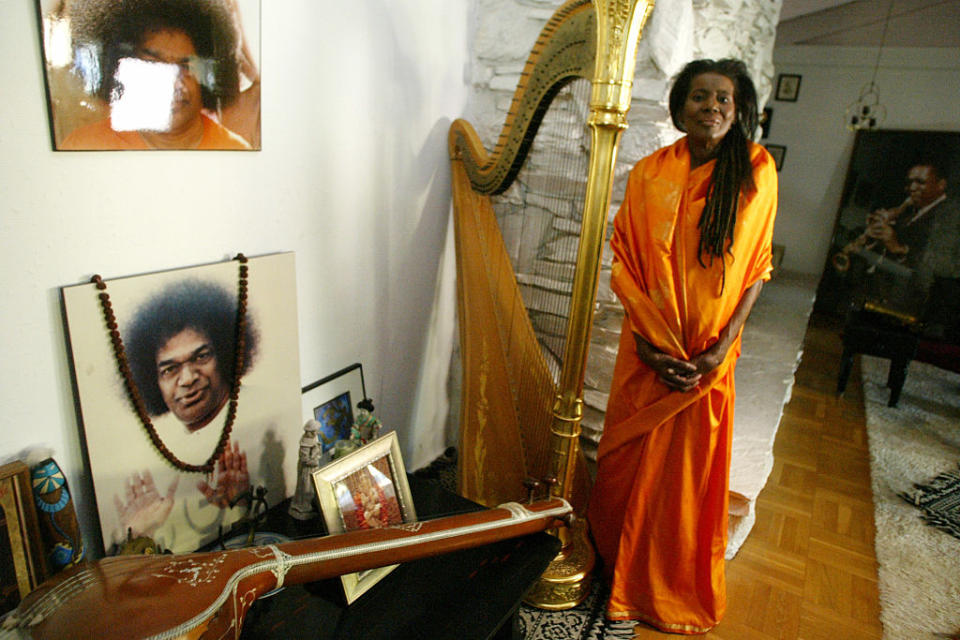 Alice Coltrane next to her shrine to her guru, Satya Sai Baba. (Credit: J. Emilio Flores/Corbis via Getty Images)