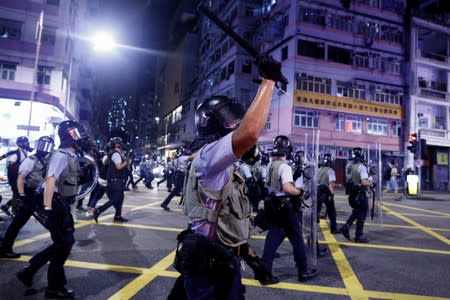 Police advance through the Sham Shui Po neighbourhood during clashes with anti-extradition bill protesters in Hong Kong