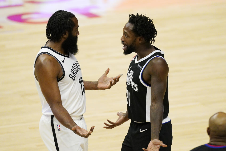 Brooklyn Nets guard James Harden, left, talks with Los Angeles Clippers guard Patrick Beverley after a confrontation in the first half of an NBA basketball game Sunday, Feb. 21, 2021, in Los Angeles. (AP Photo/Mark J. Terrill)