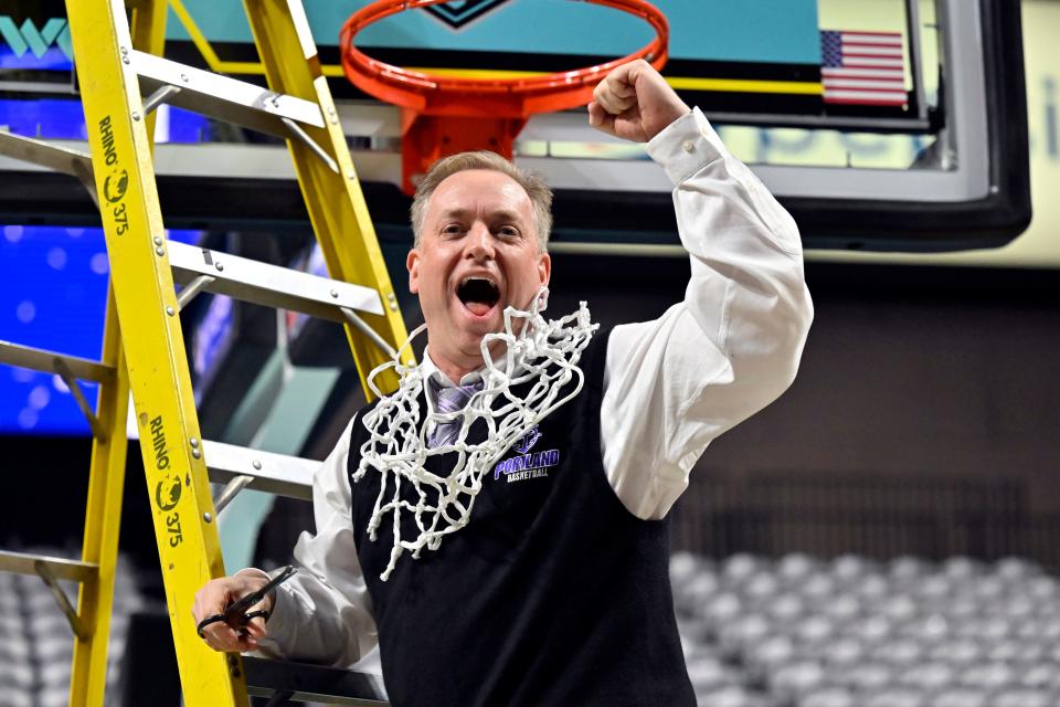 Portland coach Michael Meek celebrates with a piece of the net after defeating Gonzaga in the West Coast Conference Tournament finals last Tuesday in Las Vegas.