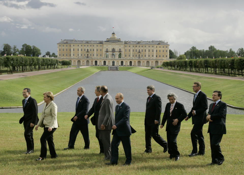 FILE - In this July 16, 2006, file photo G8 leaders from left, Italy's Prime Minister Romano Prodi, German Chancellor Angela Merkel, U.S. President George W. Bush, British Prime Minister Tony Blair, French President Jacques Chirac, Russian President Vladimir Putin, Canadian Prime Minister Stephen Harper, Japan's Prime Minister Junichiro Koizumi, Finnish Prime Minister Matti Vanhanen and European Commission President Jose Manuel Barroso, walk off following a group photo in front of the Konstantinovsky Palace in St. Petersburg, Russia. The G-7 is an informal club of rich democracies that aim to enhance their friendship and synchronize their views. (AP Photo/Alexander Zemlianichenko, File)