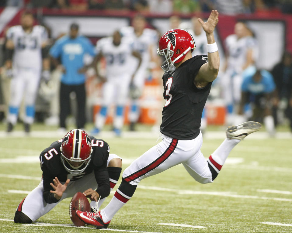 Atlanta Falcons holder Matt Bosher holds the ball as kicker Matt Bryant (2), kicks the winning field goal against the Carolina Panthers in the second half of their NFL football game in Atlanta, Georgia September 30, 2012. REUTERS/Tami Chappell (UNITED STATES - Tags: SPORT FOOTBALL TPX IMAGES OF THE DAY)