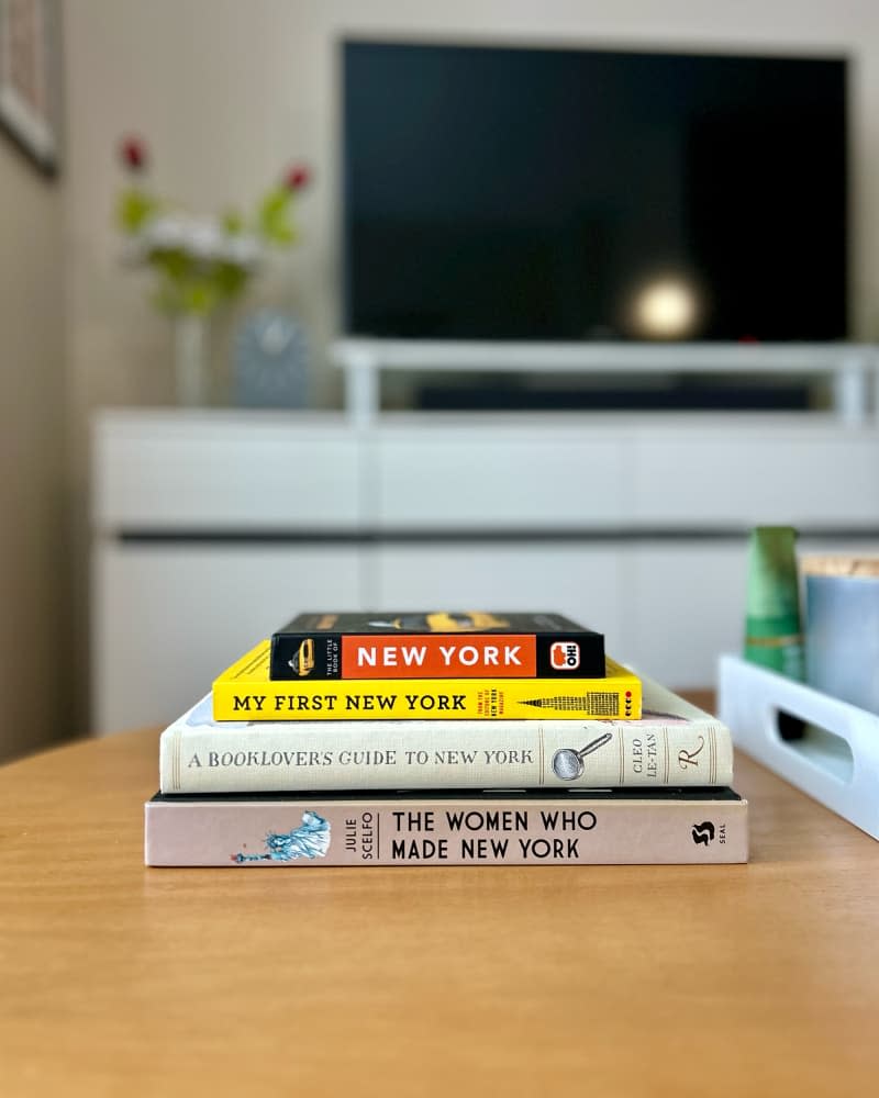 Books stacked on coffee table.