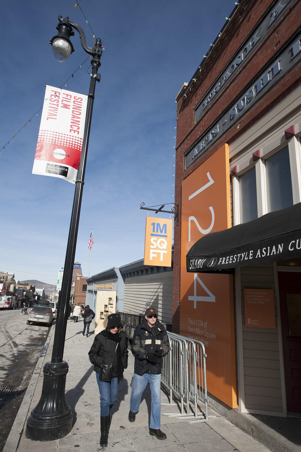 People walk down a street during the Sundance Film Festival on Thursday, Jan. 16, 2014, in Park City, Utah. The Sundance film festival runs from Jan. 16 –26. (Photo by Arthur Mola/Invision/AP)