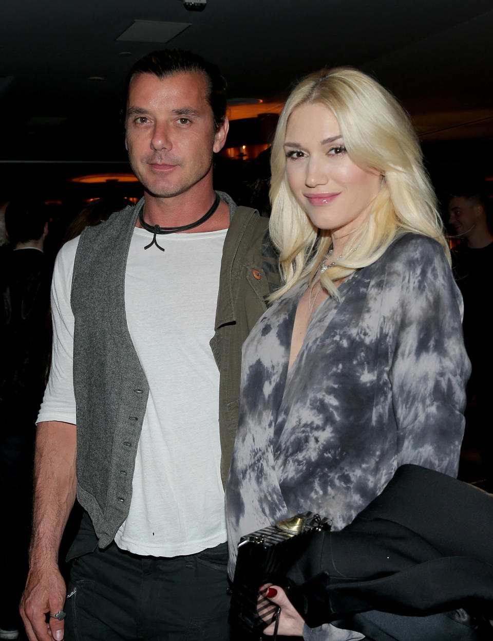 Gavin Rossdale and Gwen Stefani standing together, Stefani in a patterned top and holding a black jacket