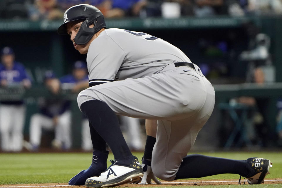 New York Yankees' Aaron Judge ducks down while leading off from third base during eighth inning in the first baseball game of a doubleheader against the Texas Rangers in Arlington, Texas, Tuesday, Oct. 4, 2022. (AP Photo/LM Otero)