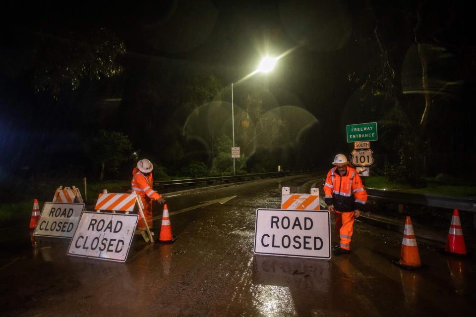 Road workers close the access to the 101 Freeway at Olive Mill Road as a result of San Ysidro Creek overflowing due to heavy rainfall in the area on January 9, 2023, in Montecito, California. - A California town that is home to Britain's Prince Harry and wife Meghan Markle was ordered evacuated on Monday, with firefighters warning mudslides could engulf homes. Montecito, a town of about 9,000 people that is also a favorite of American entertainment royalty such as Oprah Winfrey and Jennifer Aniston, was expected to get up to eight inches (20 centimeters) of rain in 24 hours -- on hillsides already sodden by weeks of downpours.