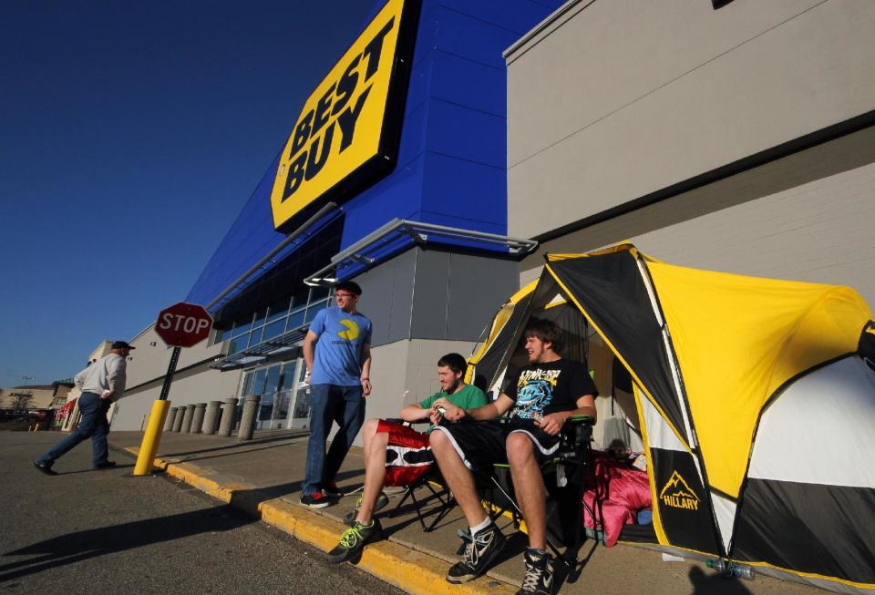 In this Nov. 21, 2012, photo, Black Friday shoppers Ryan Seech, right, Dylan Loeb, center, and Dalas Loeb, left, stake out their front of the line position at a Best Buy in West Mifflin, Pa. The Childhood friends have camped out at Best Buy for four years straight. This year, they arrived a full week early, with a tent, sleeping bags, deodorizing mist sprayer, propane heater and battery power for their gadgets. (AP Photo/Gene J. Puskar)