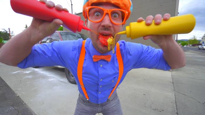 blippi squirts ketchup and mustard into his mouth