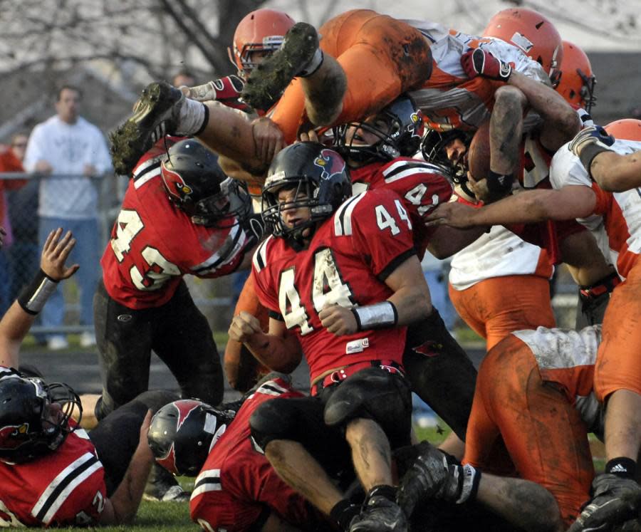 A mess of Metamora defenders stop Rochester quarterback Sean Robinson from scoring the game-winning two-point conversion in a 2009 Class 4A state semifinal game at Malone Field in Metamora.