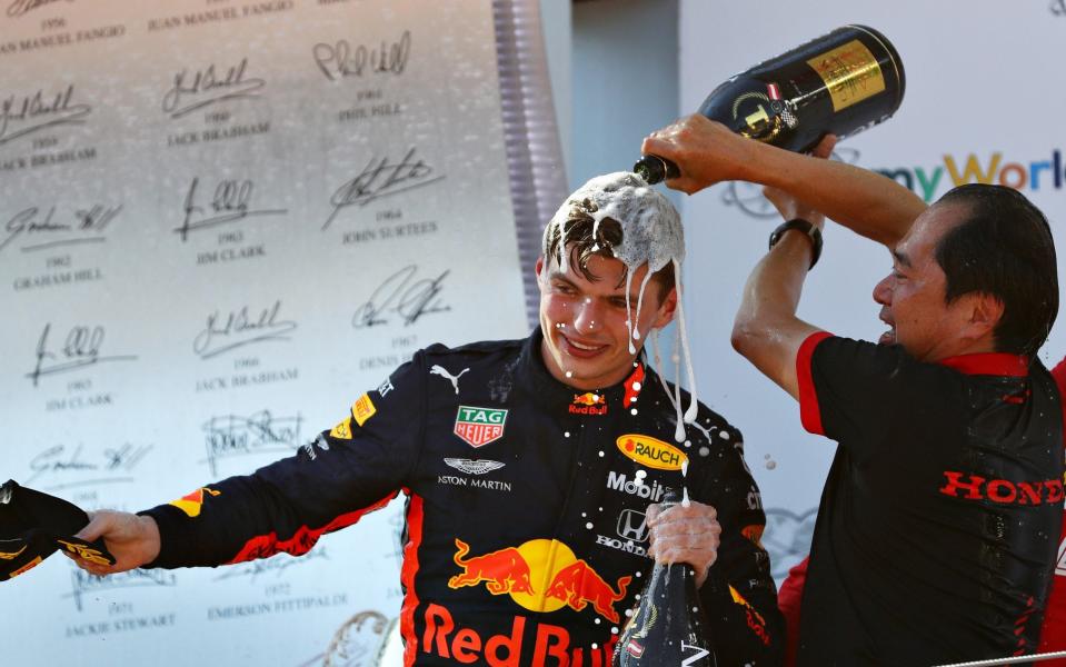 Max Verstappen is doused in champagne by Honda's Toyoharu Tanabe after winning the Austrian Grand Prix - Honda's first win in nearly 13 years - Getty Images Europe