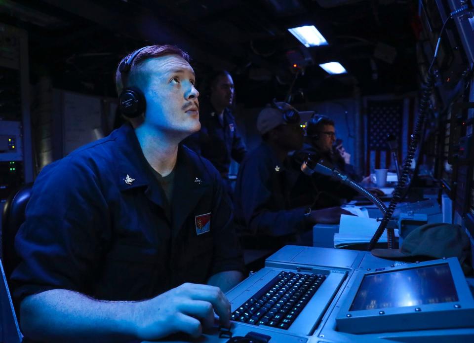 Navy sailor looks at screen during anti-submarine exercise on destroyer