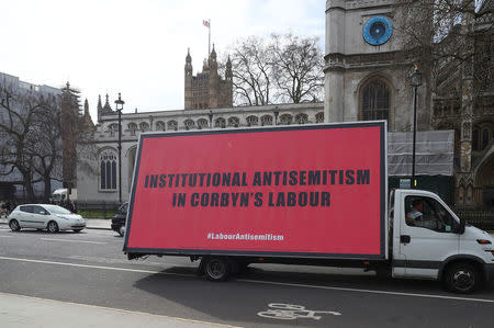 A van with a slogan aimed at Britain's Labour Party is driven around Parliament Square ahead of a debate on antisemitism in Parliament, in London, April 17, 2018. REUTERS/Hannah McKay