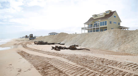 Dozers spread out sand to replenish the heavily eroded shoreline at Flagler Beach, Florida, U.S., January 26, 2018. Picture taken January 26, 2018. REUTERS/Gregg Newton