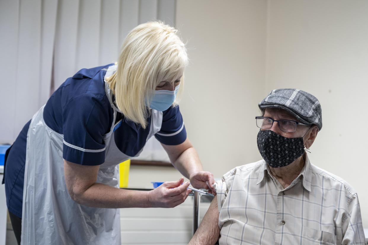 MERTHYR TYDFIL, WALES - JANUARY 04: A nurse administers the Oxford-AstraZeneca vaccine to a patient at Pontcae Medical Practice on January 4, 2021 in Merthyr Tydfil, Wales. The Oxford-AstraZeneca COVID-19 vaccine was administered at a handful of hospitals today before being rolled out to hundreds of GP-led sites across the country this week. (Photo by Matthew Horwood/Getty Images)