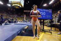 Auburn gymnast Sunisa Lee waits to perform at the University of Michigan, Saturday, March 12, 2022, in Ann Arbor, Mich. A record crowd came out to watch Lee, the reigning Olympic champion, and Auburn take on defending national champion Michigan. The arrival of Lee and several of her Olympic teammates at the collegiate level is helping fuel a spike in interest and participation in NCAA women's gymnastics. (AP Photo/Carlos Osorio)