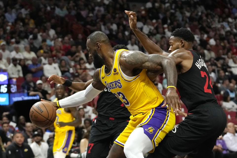 Los Angeles Lakers forward LeBron James (23) drives to the basket as Miami Heat forward Haywood Highsmith (24) defends during the first half of an NBA basketball game, Monday, Nov. 6, 2023, in Miami. (AP Photo/Lynne Sladky)