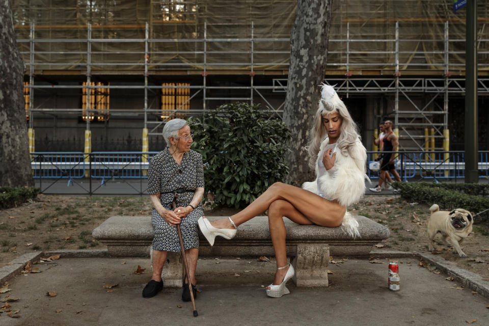 <p>A woman looks on as a participant poses for pictures during the Gay Pride parade in Madrid, July 2, 2016. (Photo: Daniel Ochoa de Olza/AP) </p>