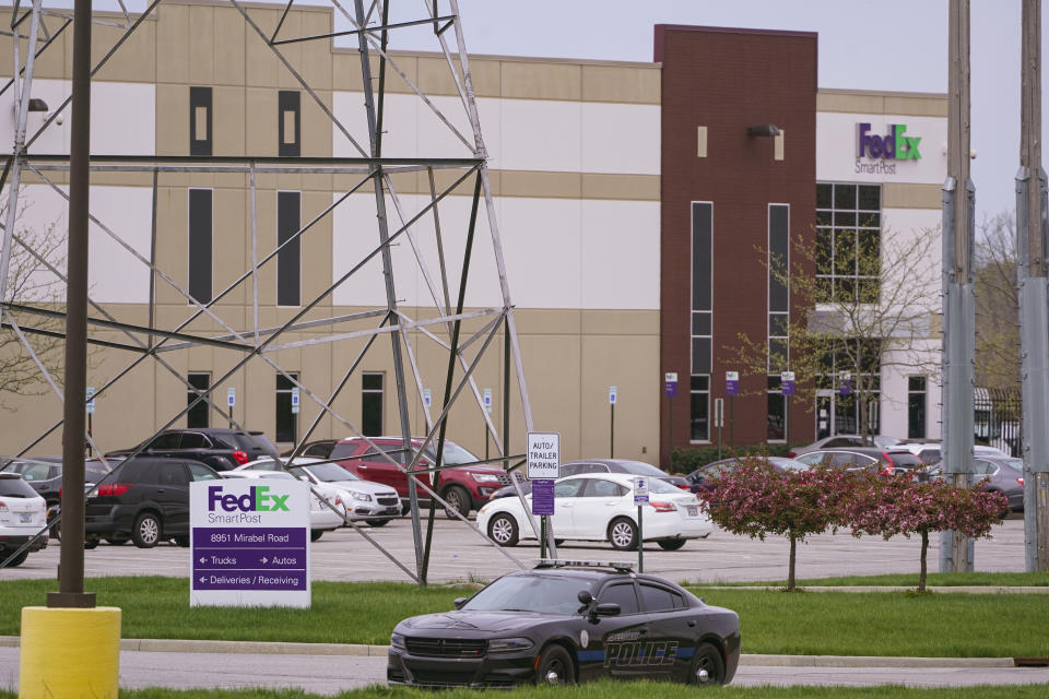 FILE - A sheriff's car blocks the entrance to the FedEx facility in Indianapolis, April 17, 2021, where eight people were killed during a shooting a few days prior. The son of a man killed in the 2021 mass shooting at an Indianapolis FedEx facility filed a lawsuit Thursday, April 13, 2023, with two survivors against the distributor of the 60-round magazine used by the gunman, alleging the use of reckless marketing tactics targeting young men at risk for violent behavior. (AP Photo/Michael Conroy, File)