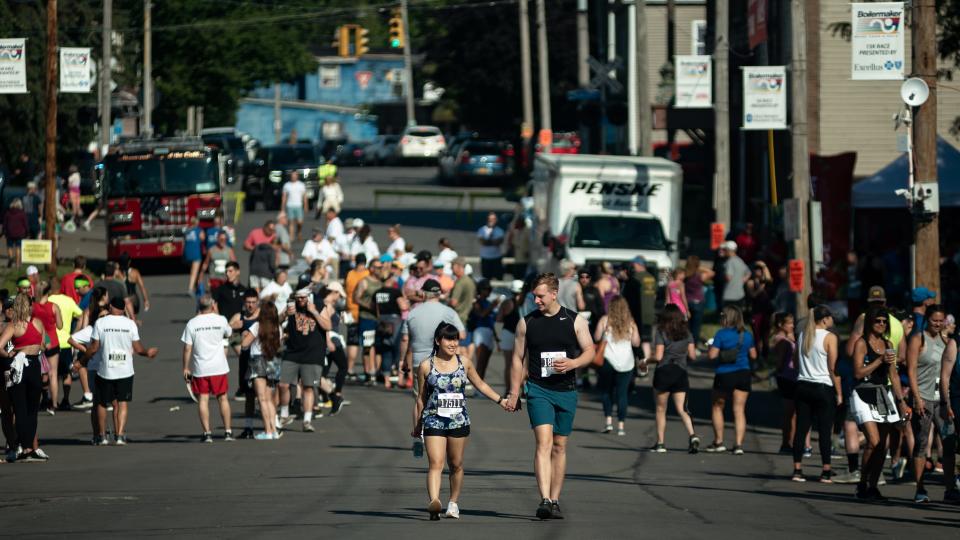 Runners of the Boilermaker Road Races make their way down to the Saranac Post Race Party in Utica on Sunday, July 10, 2022.
