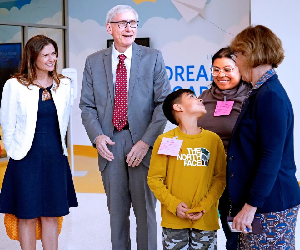 MJS Evers, adp, 6 of 6 - Zaylyn Alvarado, center, looks at his mother, Dominique, during a visit by Wisconsin Governor Tony Evers, second from left, on Monday, April 24, 2023. Also pictured are Gail Yabuki, left, family member from the Yabuki foundation and far right, Peggy Troy, far right, CEO of Children's Wisconsin hospital. Evers was in town to visit the Craig Yabuki Mental Health Walk-In Clinic at Children’s Hospital along with staff. The clinic provides same-day care for children and teens (ages 5-18) experiencing urgent mental health issues. Last August, Gov. Evers provided $5 million to Children’s Wisconsin to expand the Craig Yabuki Mental Health Walk-In Clinic and to start a pediatric psychology residency program in partnership with the Medical College of Wisconsin. Angela Peterson/Milwaukee Journal Sentinel