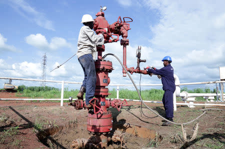 FILE PHOTO: Workers are seen at an oil well at the Toma South oil field to Heglig, in Ruweng State, South Sudan August 25, 2018. REUTERS/Jok Solomun/File Photo