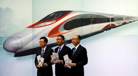 (L-R) Secretary for Security John Lee, Secretary for Justice Rimsky Yuen and Secretary for Transport & Housing Frank Chan pose at a news conference on arrangements at West Kowloon Terminus for the Guangzhou-Shenzhen-Hong Kong Express Rail Link in Hong Kong, China July 25, 2017. REUTERS/Bobby Yip