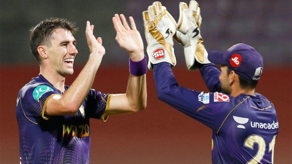 Pictured here, Kolkata's Pat Cummins takes a wicket against Mumbai in the IPL.