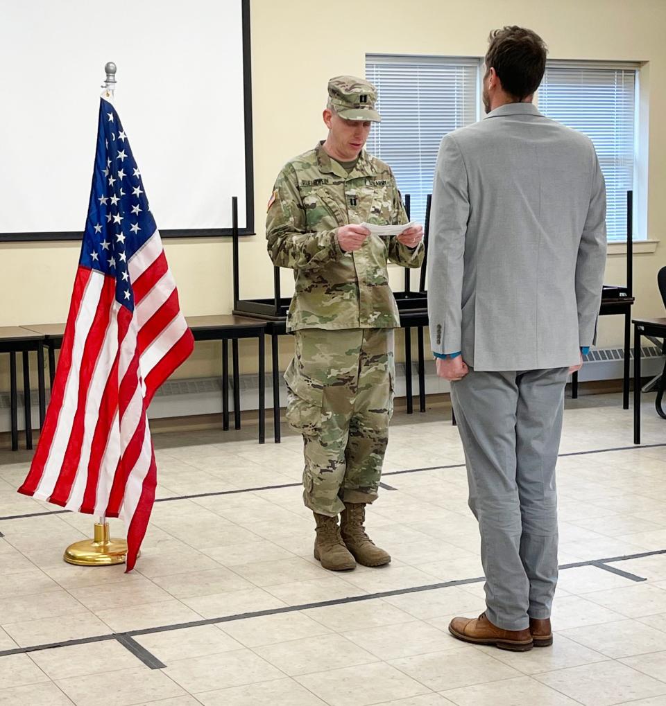 US Army Reserve Captain Blake Ruehrwein is sworn in during a ceremony at the Army National Guard Armory in Rehoboth on April 9, 2022. His older brother Chandler Ruehrwein read the oath of office at the swearing in.