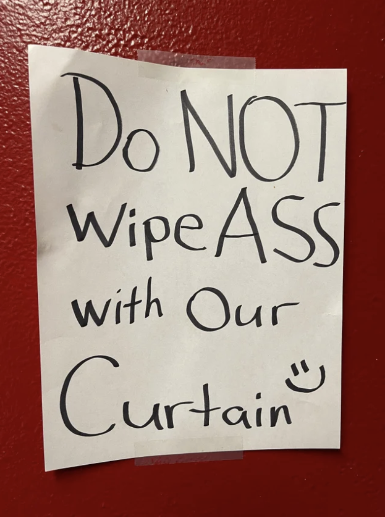 The sign says "do not wipe ass with our curtain" with a smiley face drawn at the end