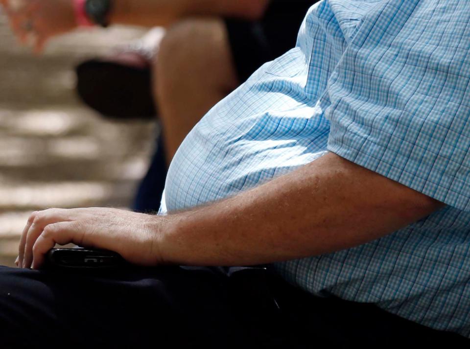 FILE - In this Thursday, Sept. 4, 2014, file photo, an overweight man rests on a bench in Jackson, Miss. Rising numbers of American adults have the most dangerous kind of obesity, belly fat, despite evidence that overall obesity rates may have plateaued, government data shows. Abdominal obesity affects 54 percent of U.S. adults, versus 46 percent in 1999-2000, and the average waist size crept up an inch, too, according to the most recent statistics. (AP Photo/Rogelio V. Solis, File) ORG XMIT: NY202