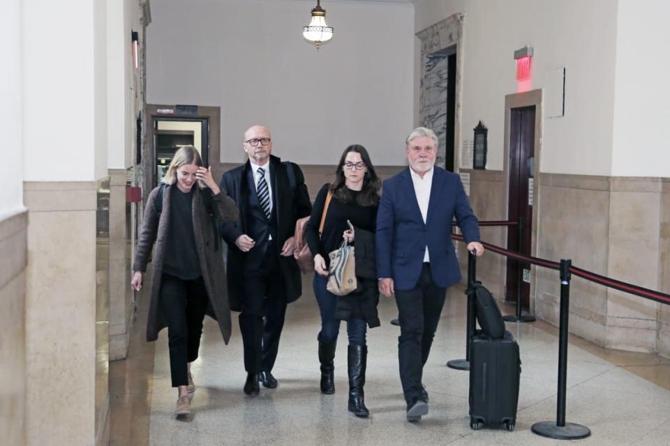 <div class="inline-image__caption"><p>Mike Rinder, right, is seen leaving court with Paul Haggis, center.</p></div> <div class="inline-image__credit">Dorian Geiger</div>