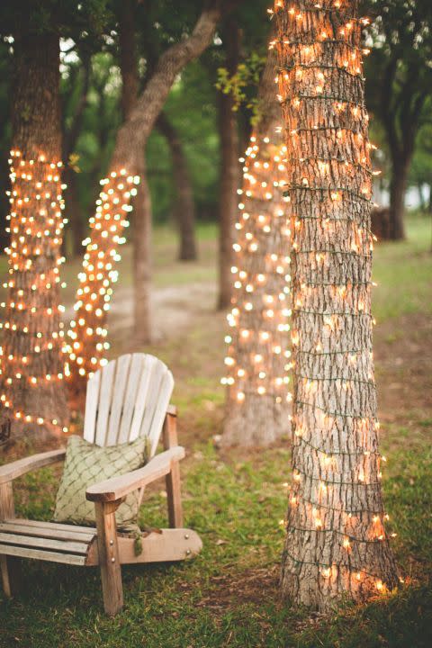 <p>Create a romantic spot by twisting a string of white lights around a cluster of trees in your backyard. Not only will this create an enchanting place to sit in the evenings, but it will be charming to look at from inside your home.</p><p><strong>See more at <a href="http://www.stevenmichaelphoto.com/2011/06/23/ruben-elise-wedding-photographer-decatur-tx/" rel="nofollow noopener" target="_blank" data-ylk="slk:Steven Michael Photography;elm:context_link;itc:0;sec:content-canvas" class="link ">Steven Michael Photography</a>.</strong></p><p><strong><strong><a class="link " href="https://www.amazon.com/Prextex-100-Count-Clear-Christmas-Decorations/dp/B075LQ4WTF/ref=sxin_6_osp104-8d4d435c_cov?tag=syn-yahoo-20&ascsubtag=%5Bartid%7C10050.g.3404%5Bsrc%7Cyahoo-us" rel="nofollow noopener" target="_blank" data-ylk="slk:Shop Christmas lights;elm:context_link;itc:0;sec:content-canvas">Shop Christmas lights</a></strong><br></strong></p>