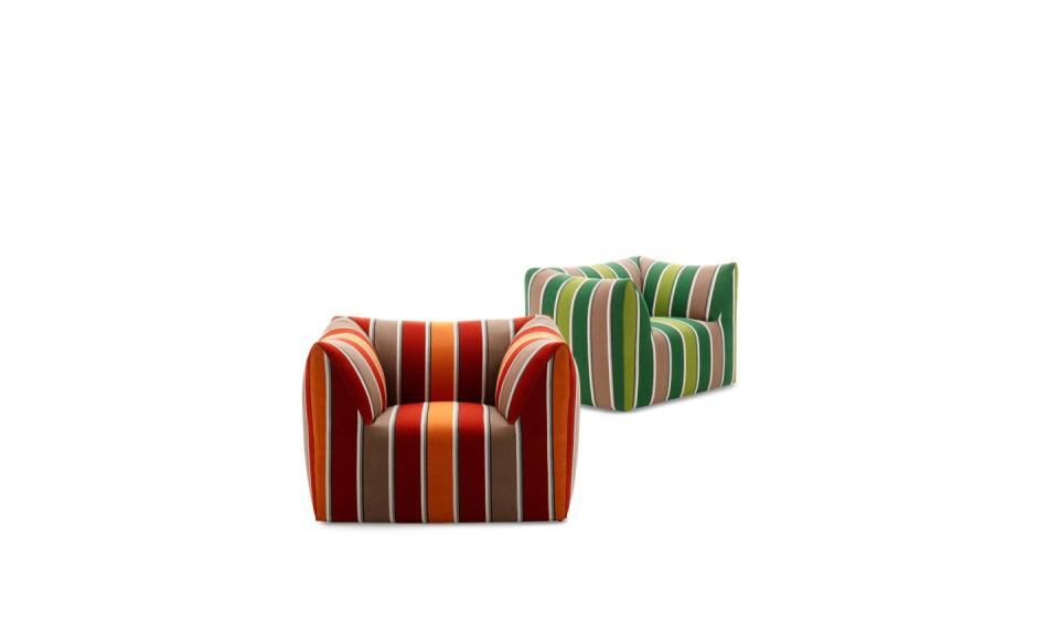 two chunky armchairs one in hues of red and the other in hues of green