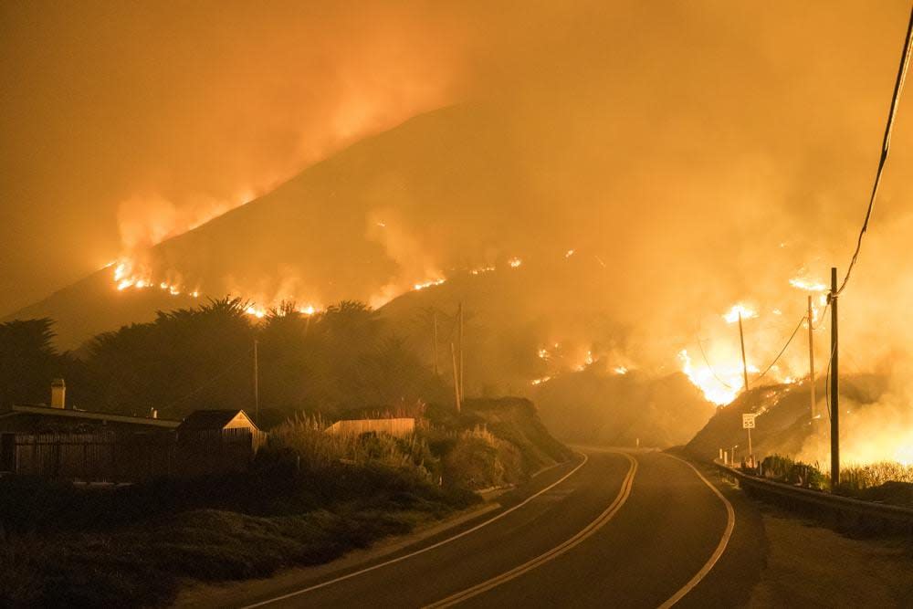 The Colorado Fire burns along Highway 1 near Big Sur, Calif., Saturday, Jan. 22, 2022. (AP Photo/Nic Coury)