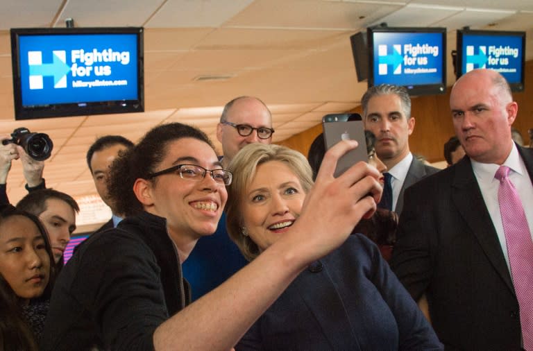 Democratic presidential candidate Hillary Clinton takes a selfie with supporters after speaking during a campaign stop in Adel, Iowa