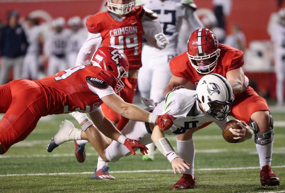 Crimson Cliffs’ McKay Wright (34) and Parker Andrus (53) tackle Ridgeline’s Indiana Judd during a 4A semifinal football game at Rice-Eccles Stadium in Salt Lake City on Friday, Nov. 10, 2023. Crimson Cliffs won 31-24. | Kristin Murphy, Deseret News