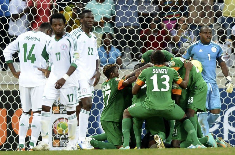 Zambia players celebrate at the team's goalkeeper scored a penalty on January 25, 2013 during an Africa Cup of Nations 2013 group A football match against Nigeria at the Mbombela stadium in Nelspruit. Zambia goalkeeper Kennedy Mweene, a noted penalty saving and taking specialist, scored from the spot to salvage a 1-1 draw against Nigeria